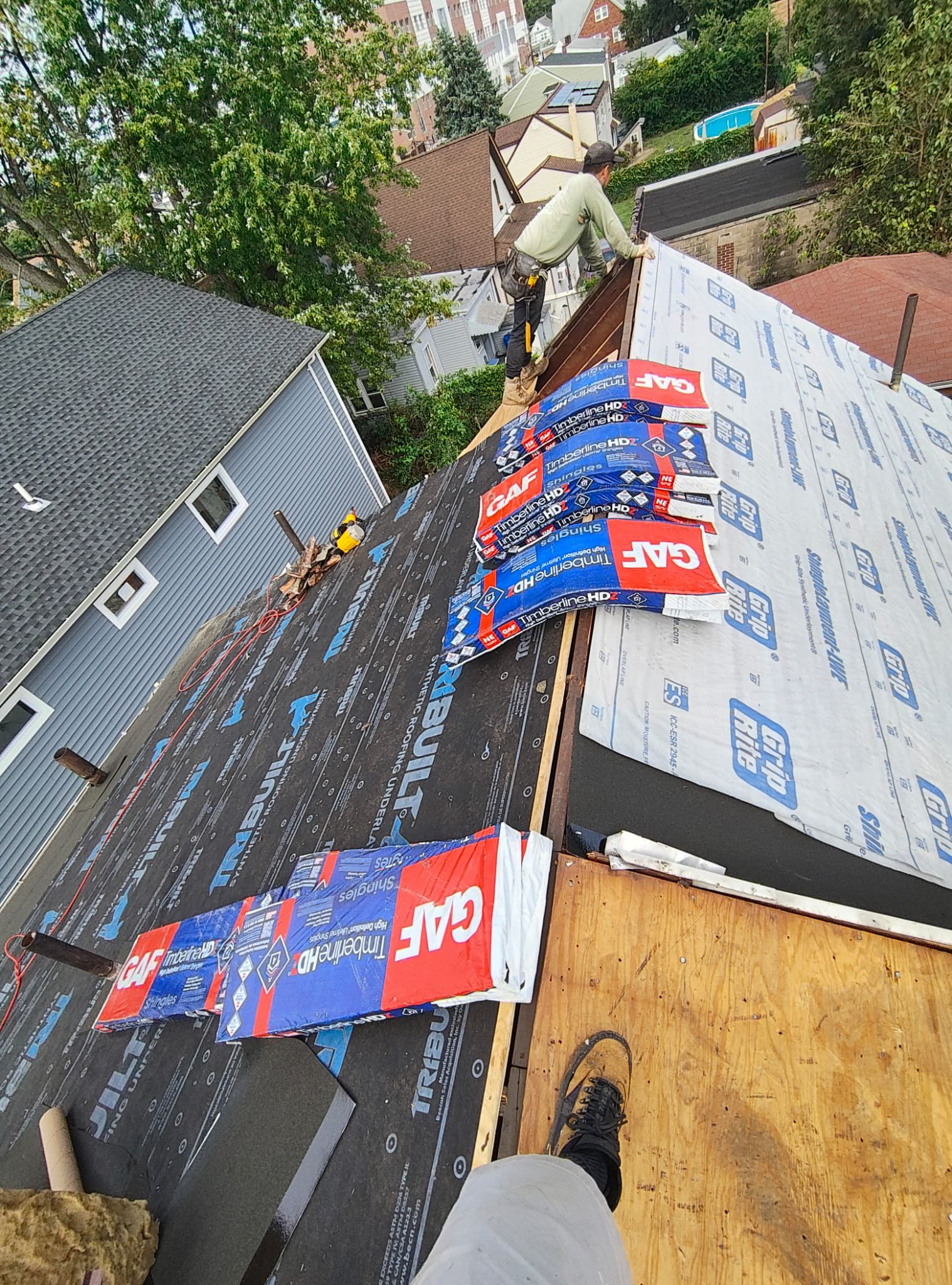 GAF designer shingle bundles staged on the prepared roof deck