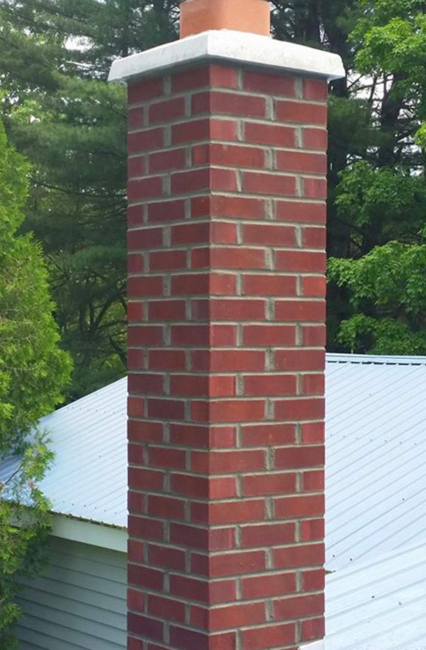 Newly rebuilt red brick chimney with terracotta clay flue and concrete crown by Randy's Roofing Construction