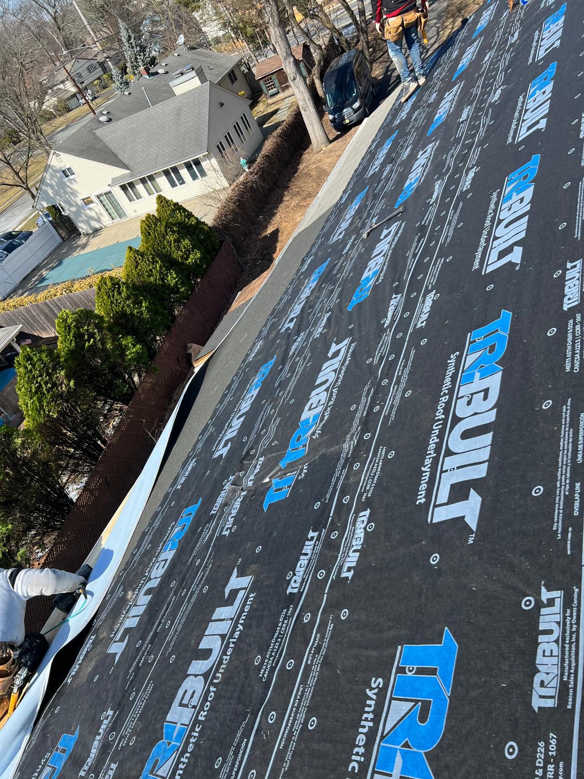 TRIBUILT synthetic roofing underlayment laid across roof deck before shingle install