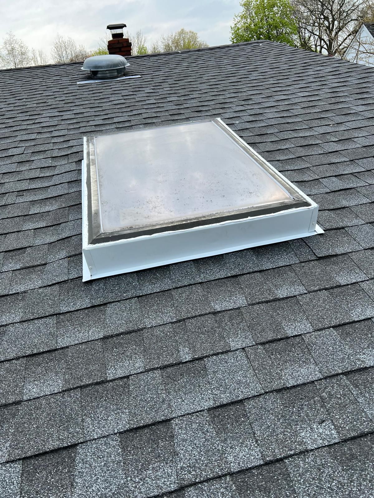 Skylight flashing replacement on a residential shingle roof