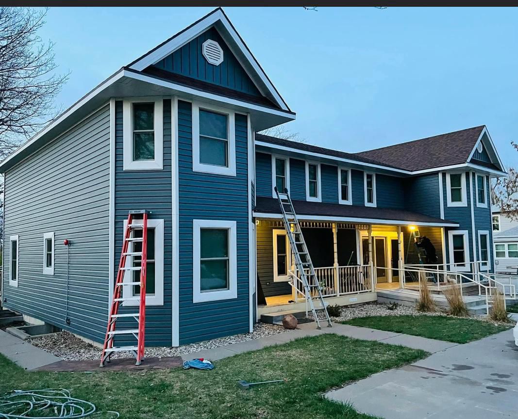 Northern NJ home with new blue and gray vinyl siding combination, board-and-batten gable accent, and white trim