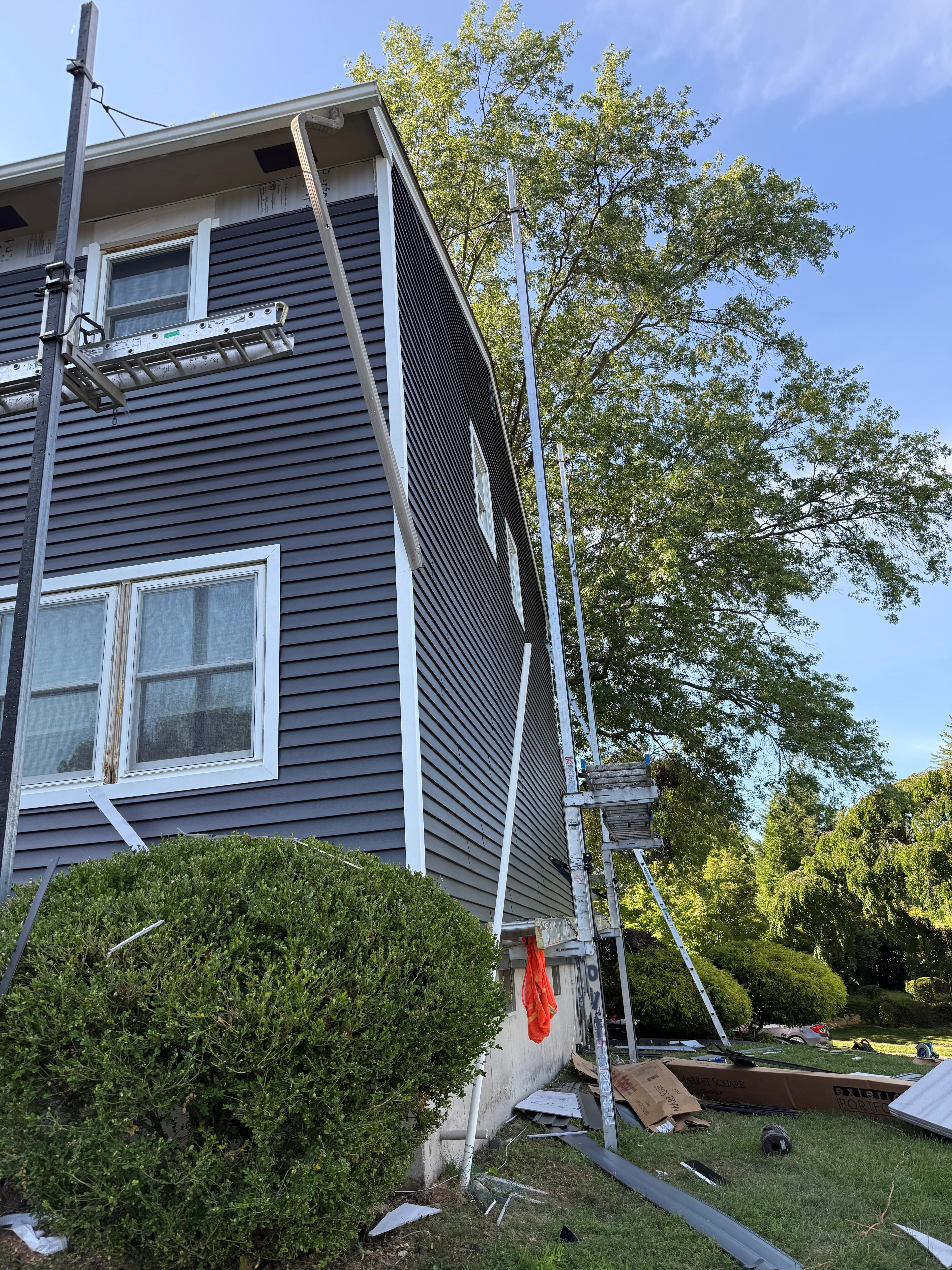 Corner detail where new navy siding meets white corner trim