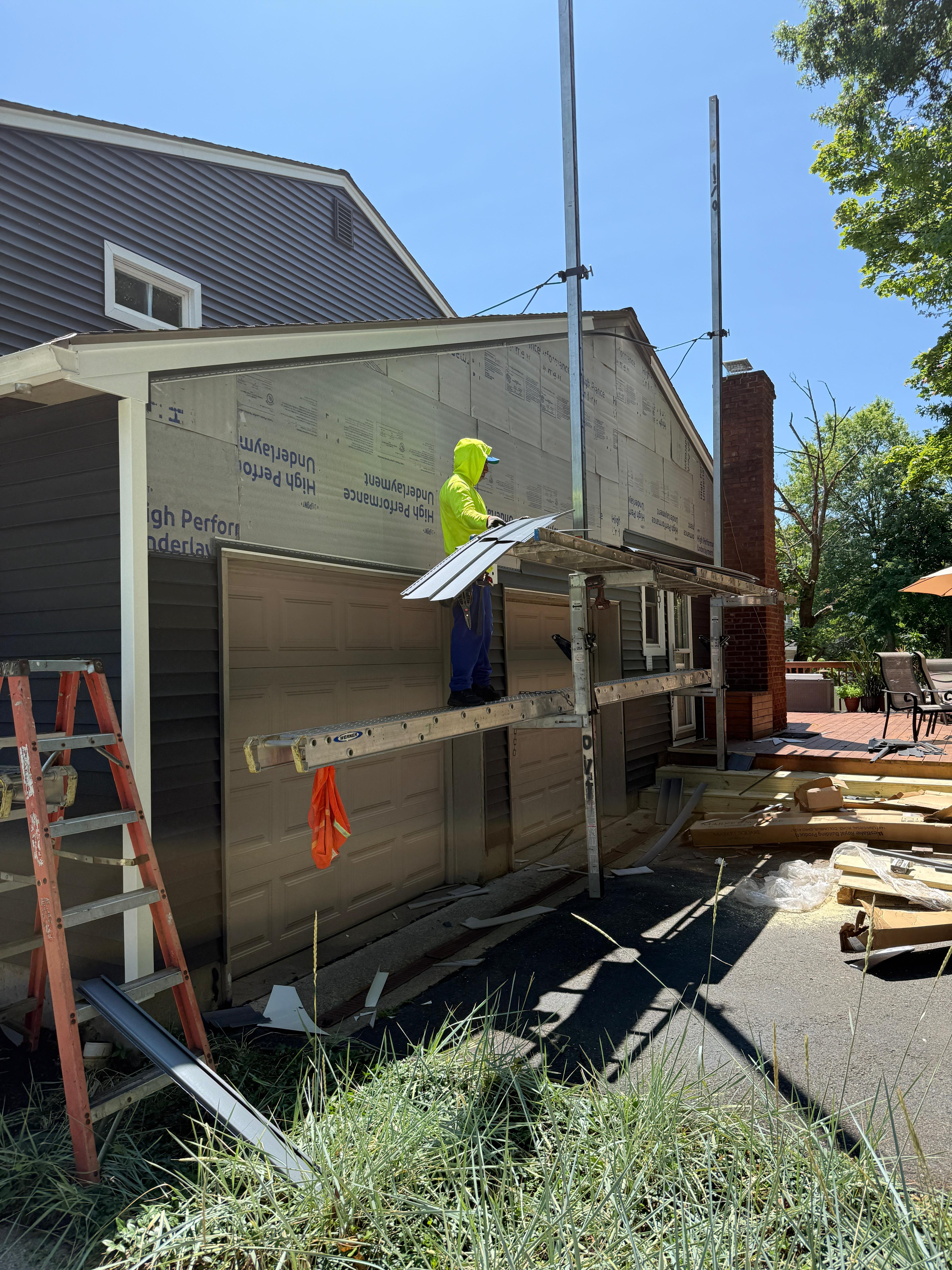 Garage wing being sided over insulated underlayment board