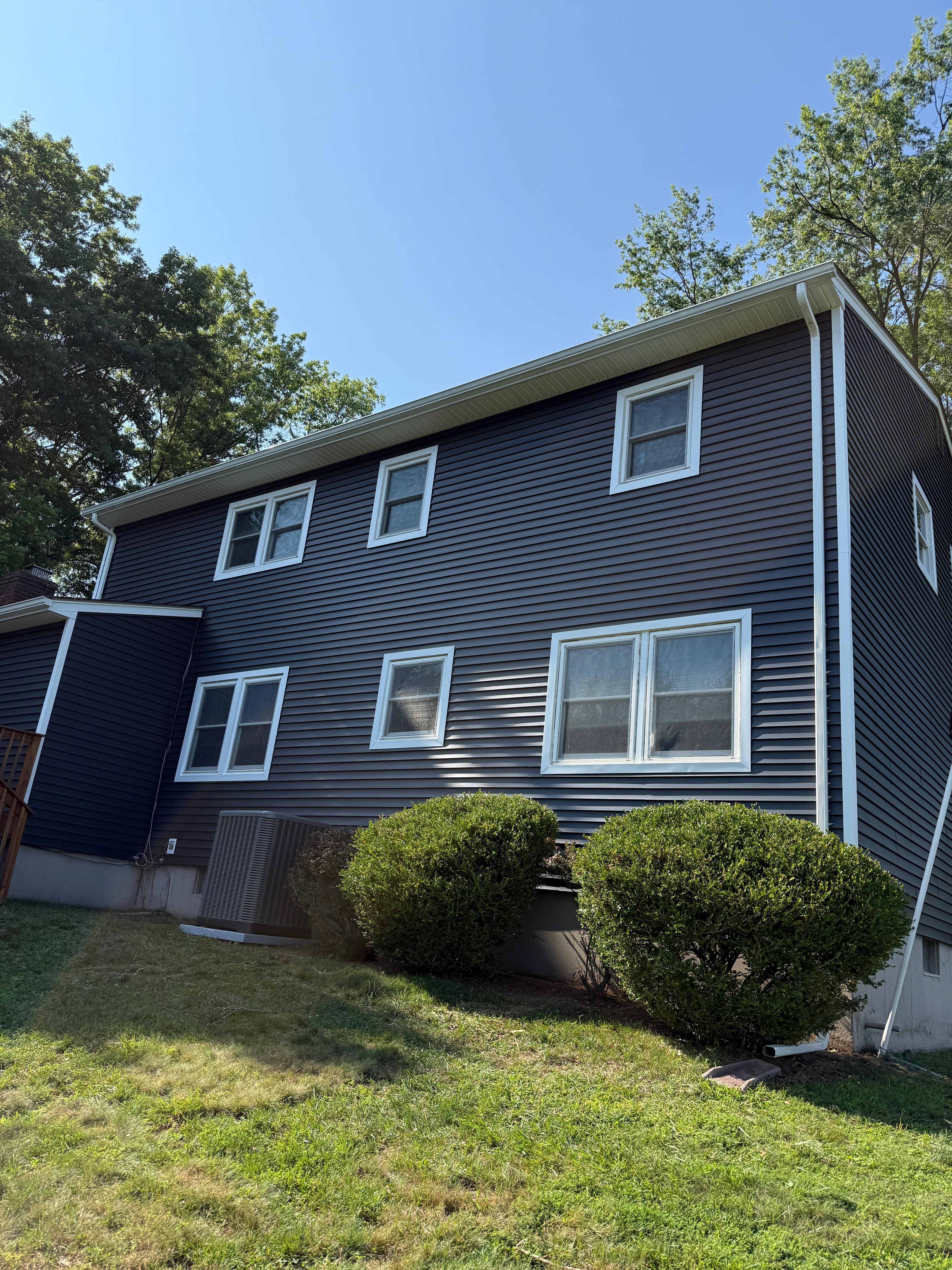 Completed rear elevation in navy with white trim and gutters