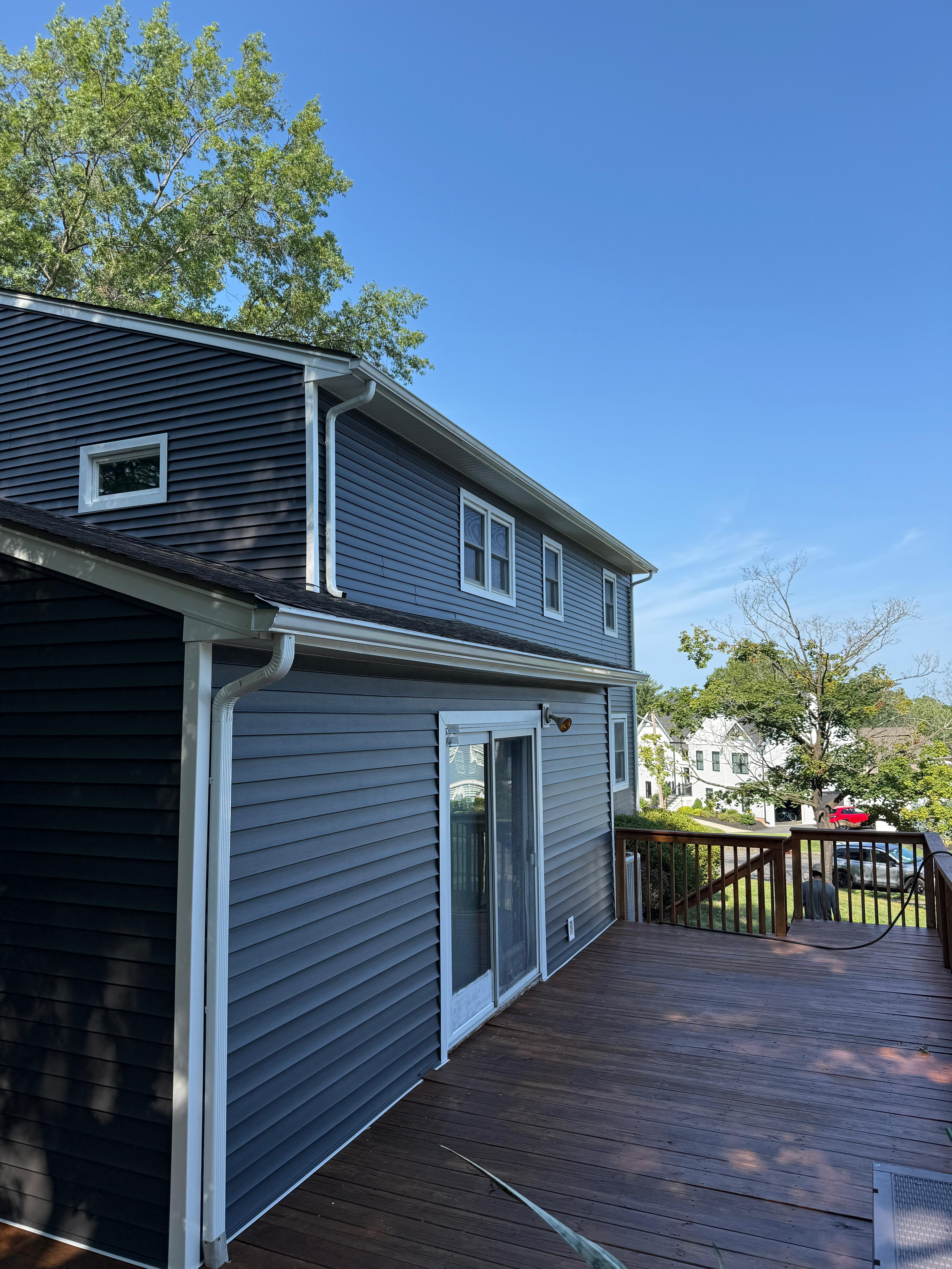 Wide view across the finished deck toward the completed rear elevation
