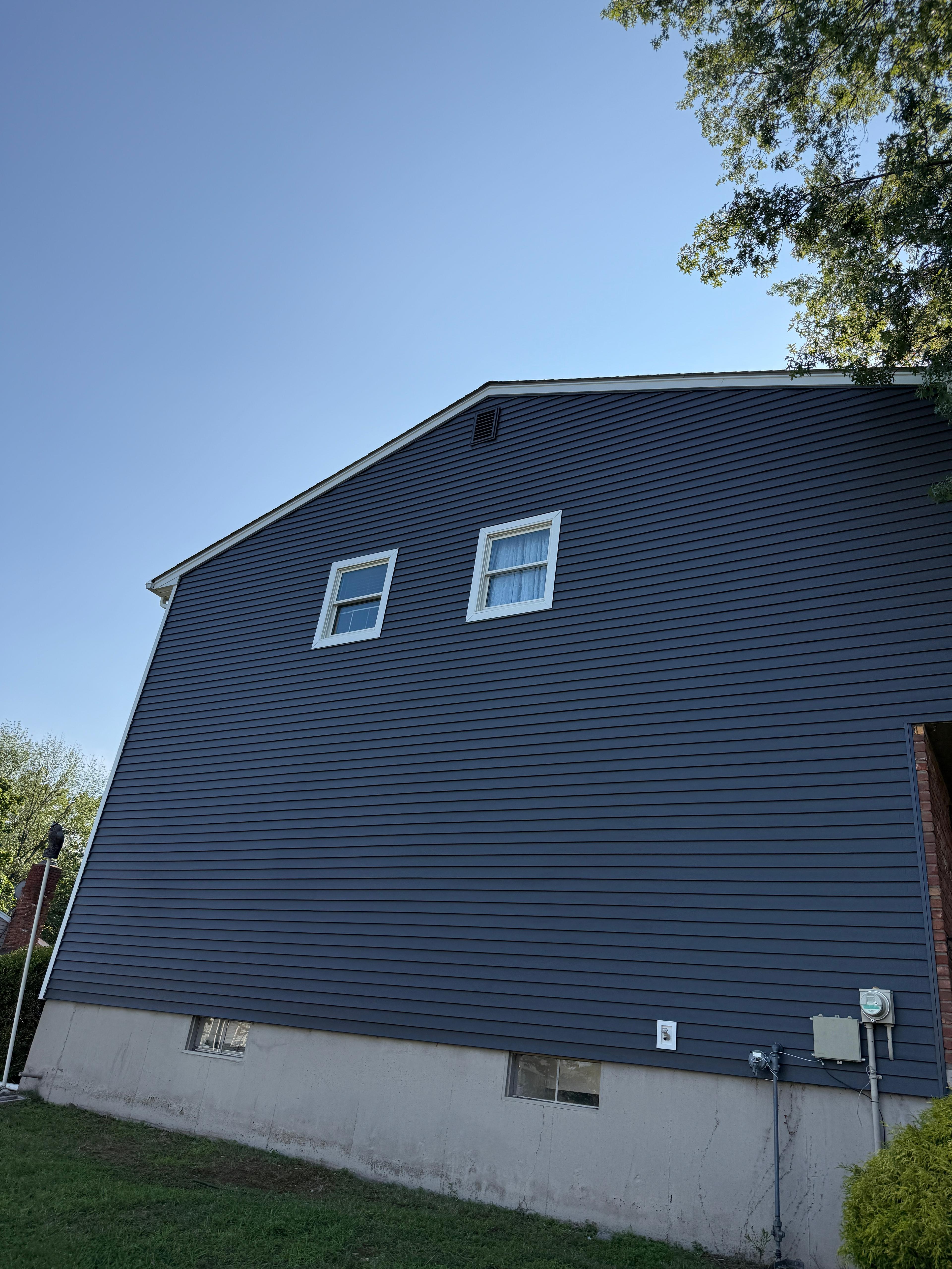 Finished tall elevation showing clean siding courses and trim