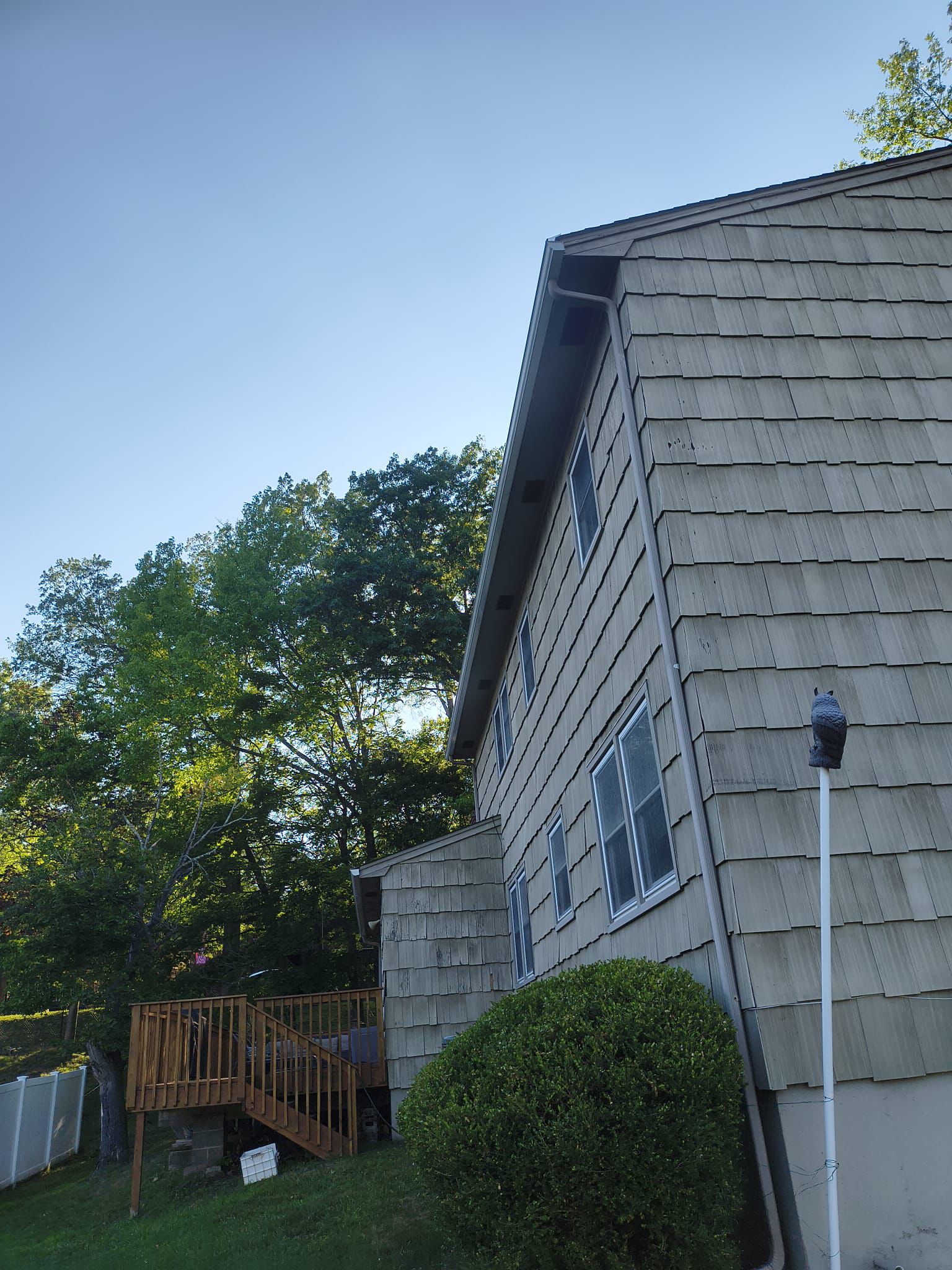 Rear elevation with weathered shake beside the wooden deck