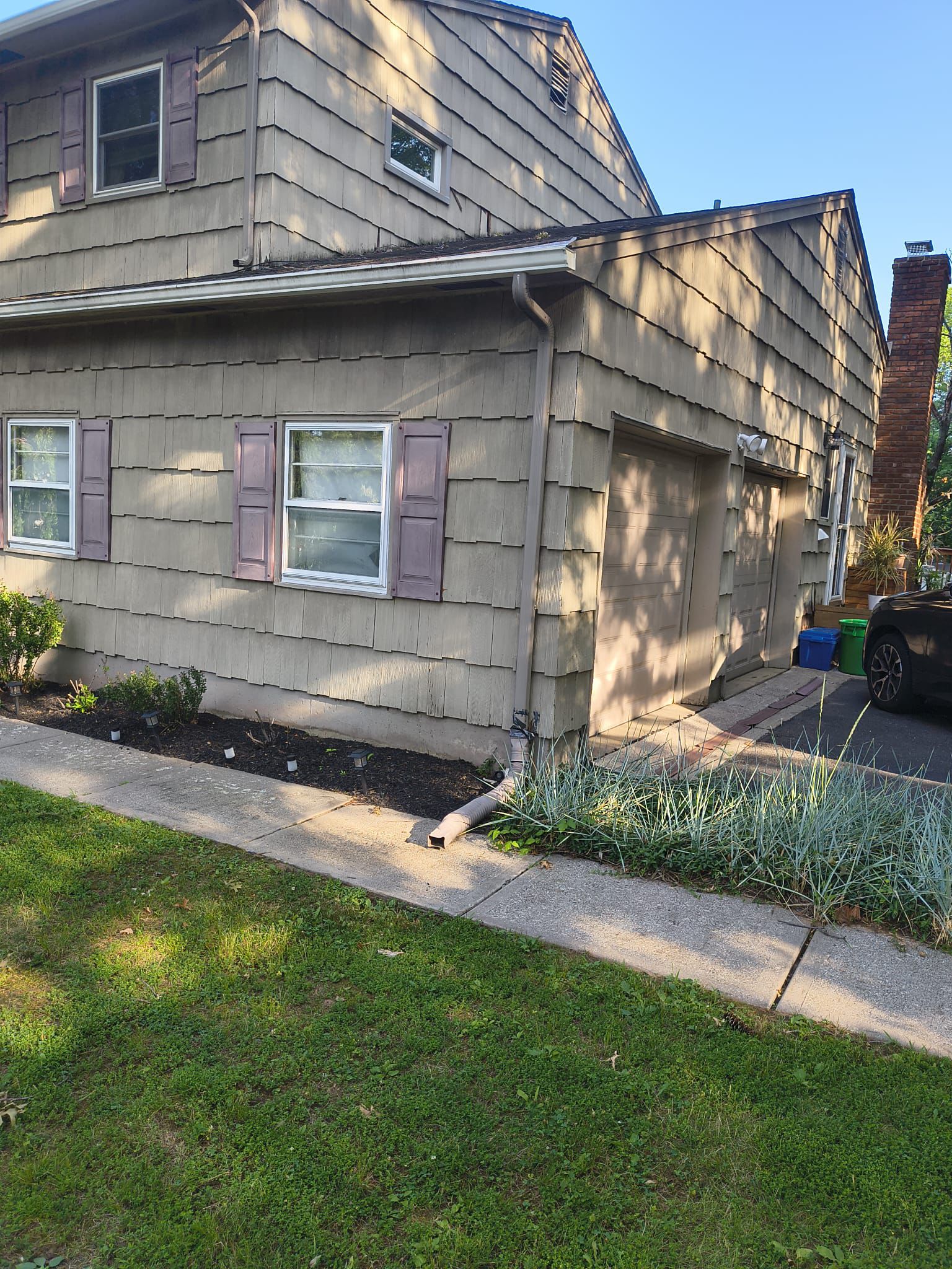 Side elevation and driveway before the siding replacement