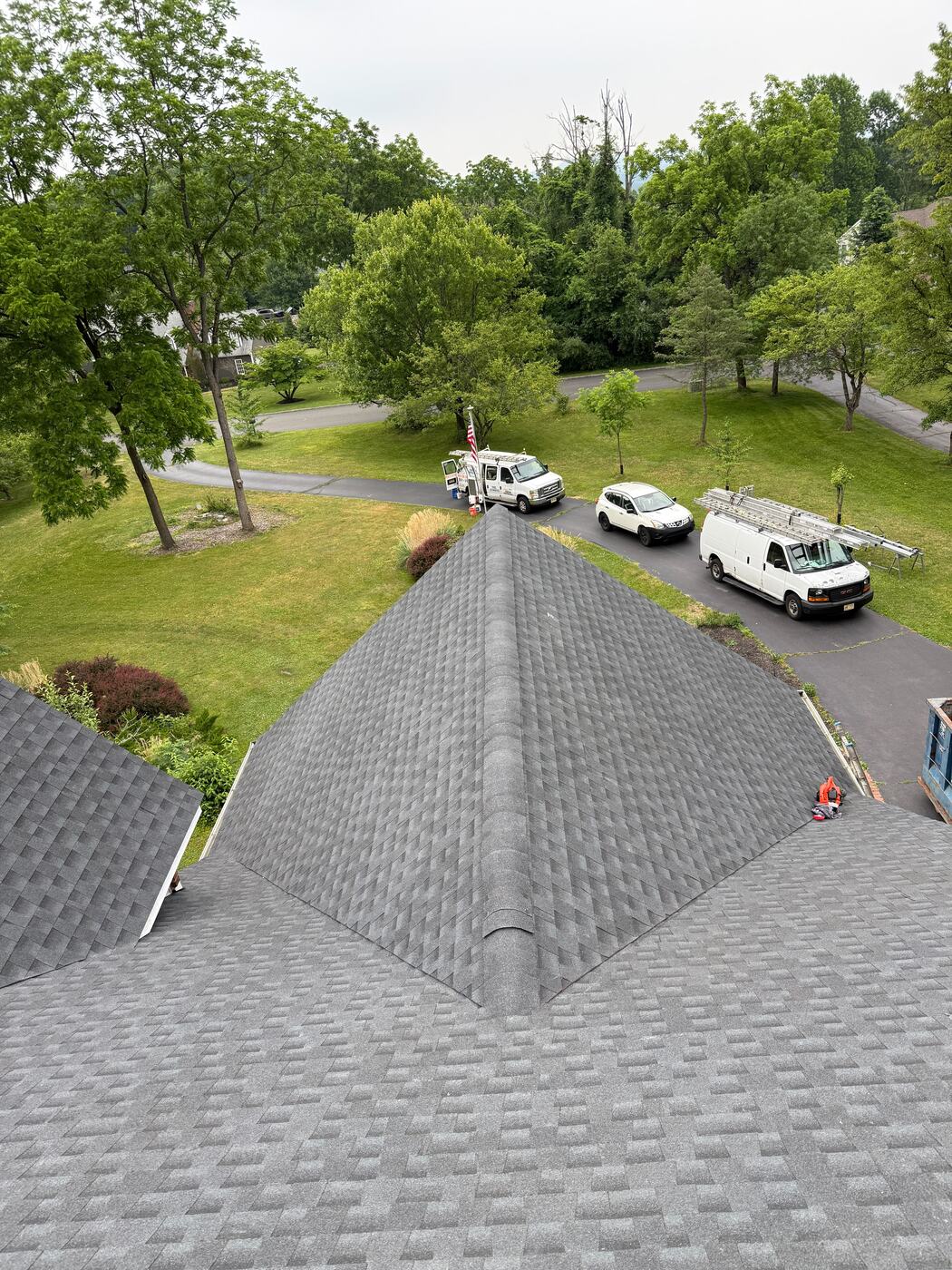 Completed multi-hip roof replacement on a wooded hillside estate in Northern NJ