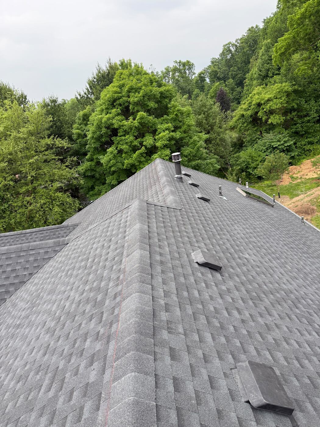 Capped hip and ridge lines meeting on the completed estate roof