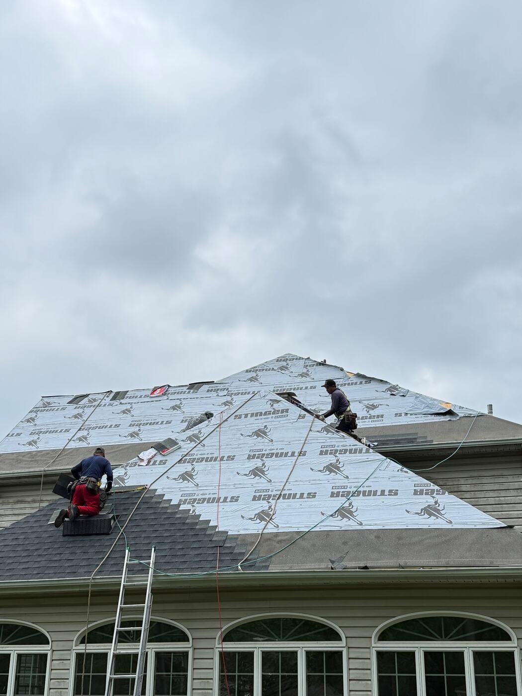 Stinger EXO25 underlayment covering the upper roof planes with shingle courses started along the lower edge